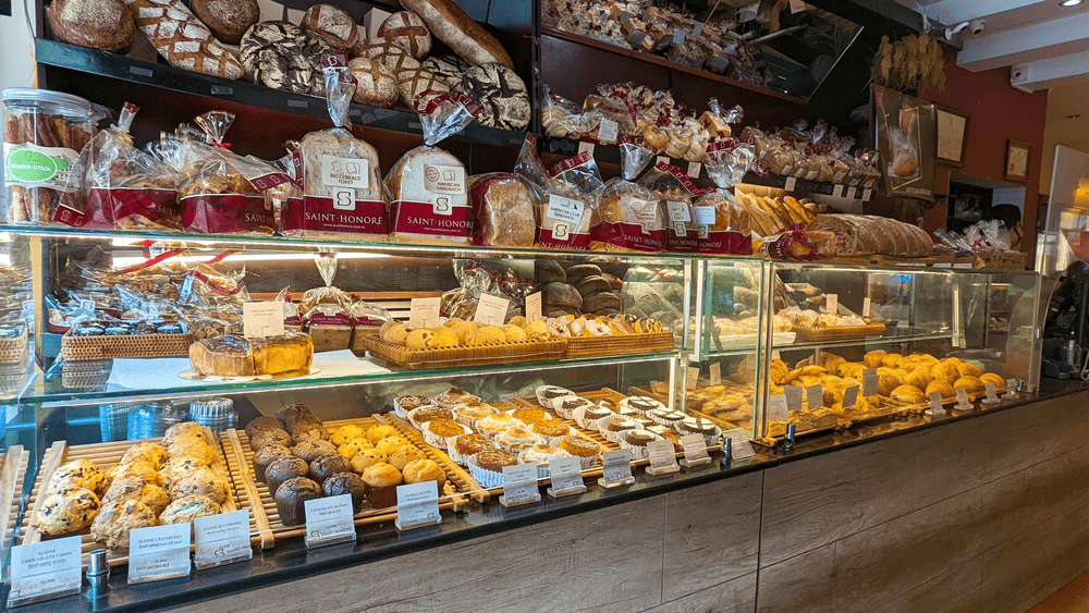 The pastry display is filled with a variety of colorful cakes and desserts (Source: Saint-Honoré Hanoi)